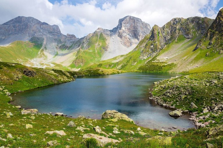 glacier lake beneath steep mountain peaks